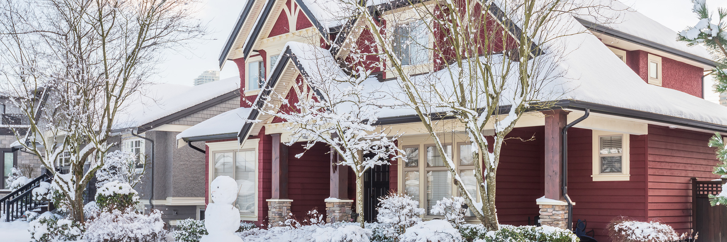 Red house in the winter covered in snow