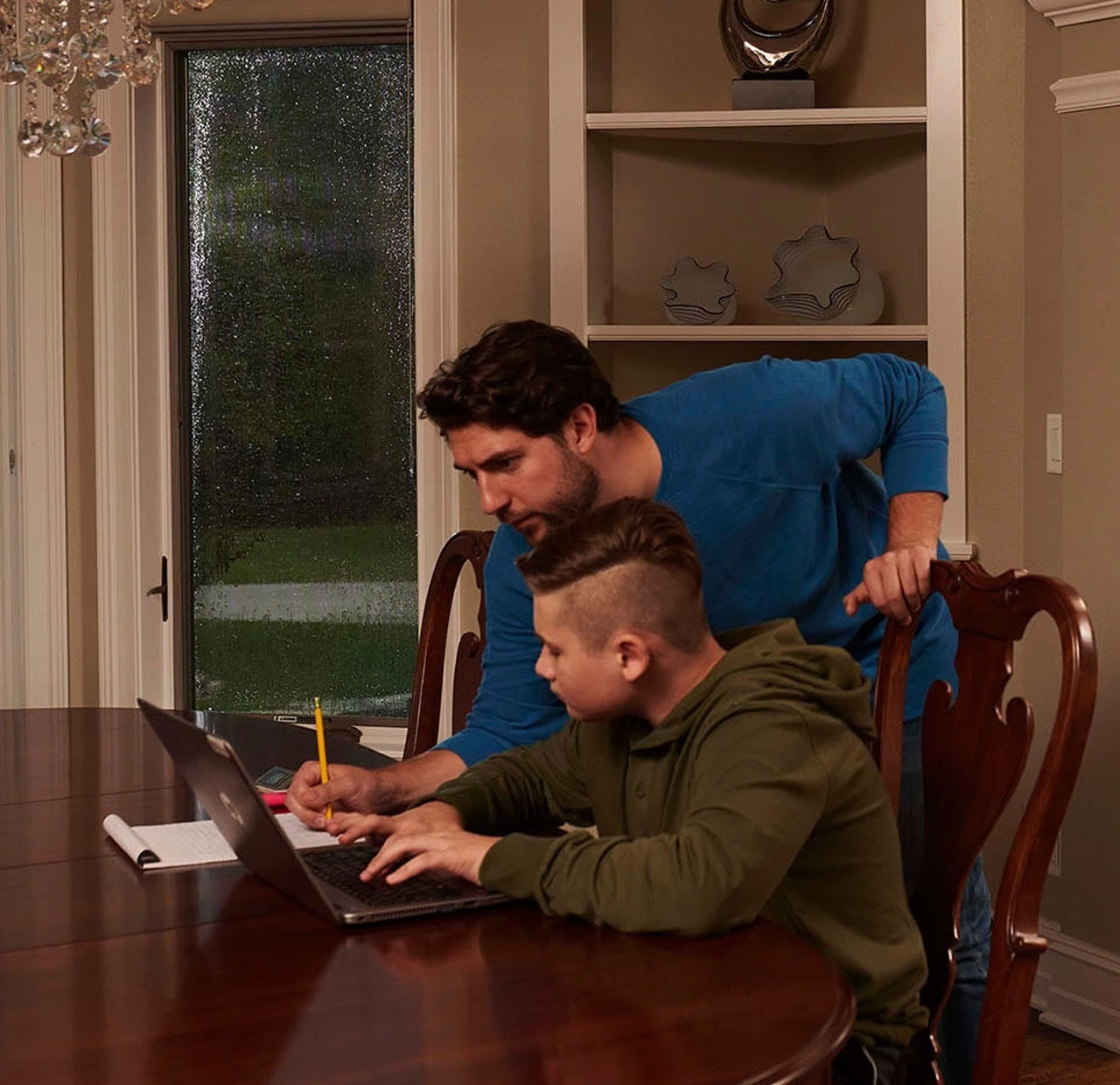 father and son looking at computer