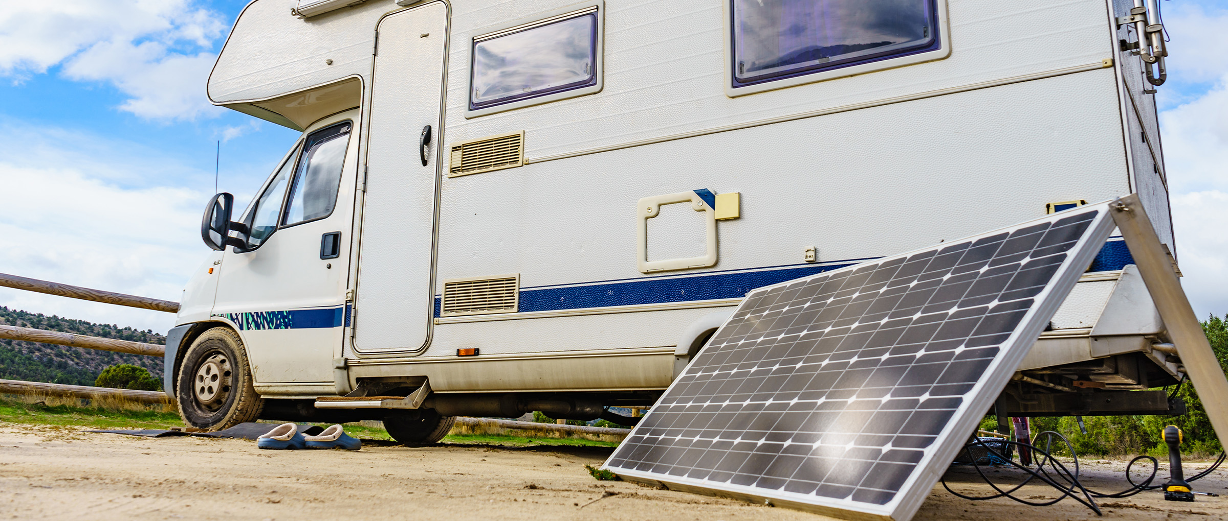 house with solar panels and lights on in forest