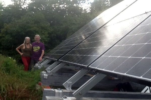 David and Lila next to their solar panels