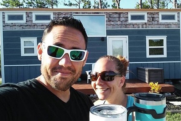 Homeowners in front of tiny, mobile home