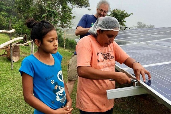 People installing and working on solar panel