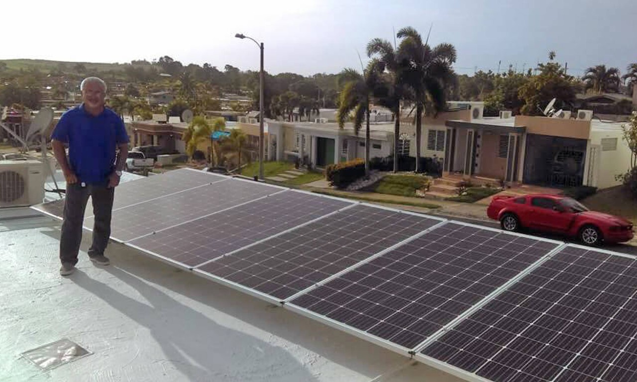 Homeowner next to solar panels