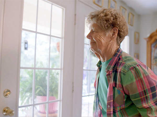 Lee Townsend's mother smiling while looking out a window