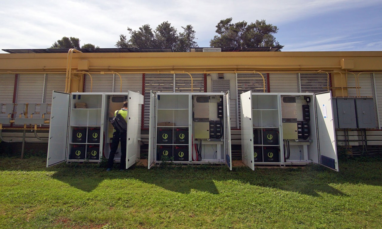 Three cabinets containing battery storage systems