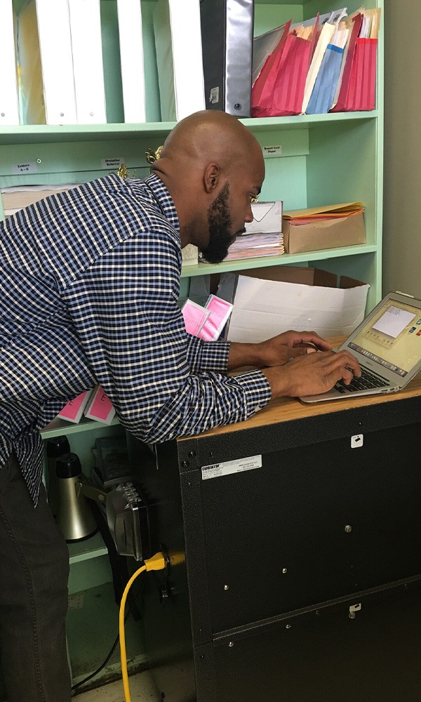 Person working on a laptop powered by PHI batteries