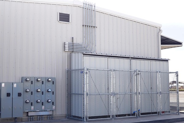 Outside a hangar houses a three-phase energy storage and solar microgrid. 