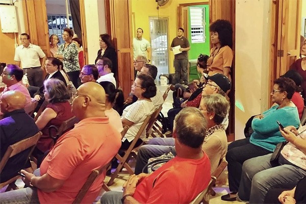 Residents listening at a community center in San Salvador