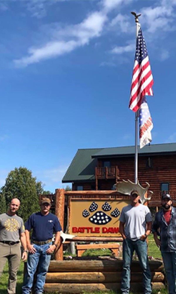 Veterans outside Battle Dawgs entrance sign