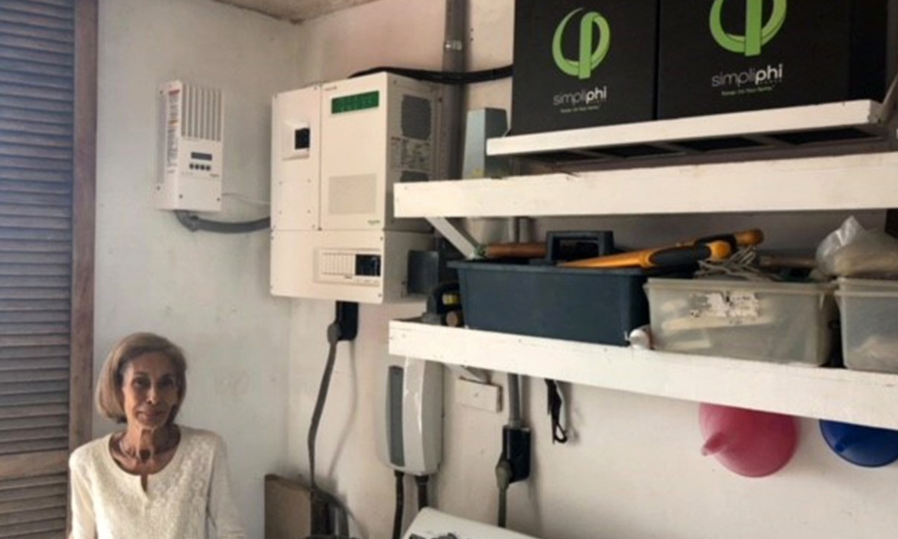 Homeowner next to their battery storage system